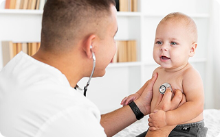 Pediatric Cardiologist checking a child’s heartbeat with a stethoscope